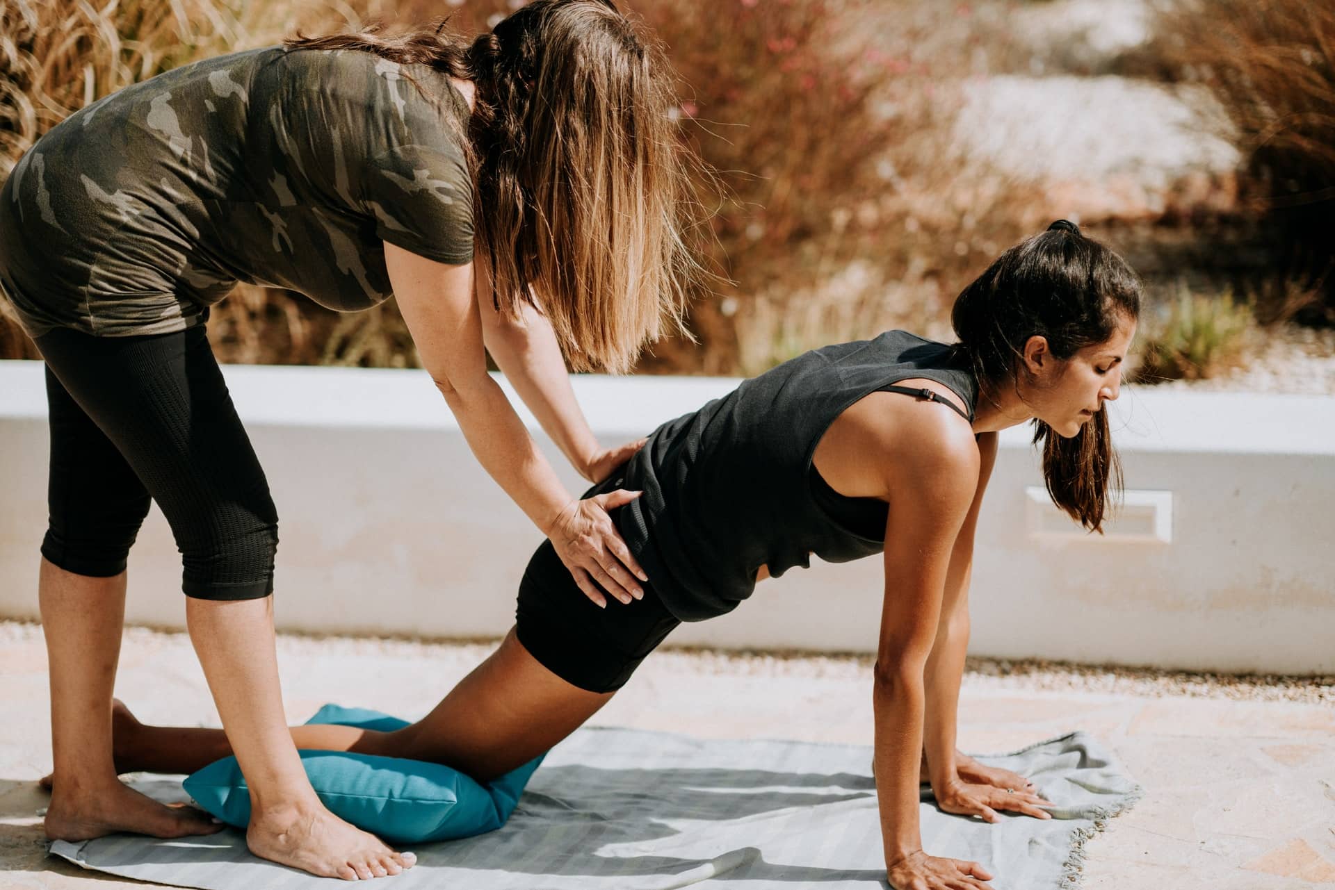 A trainer working with a patient on stretches representing how physical therapy can assist people injured in a car acciddent