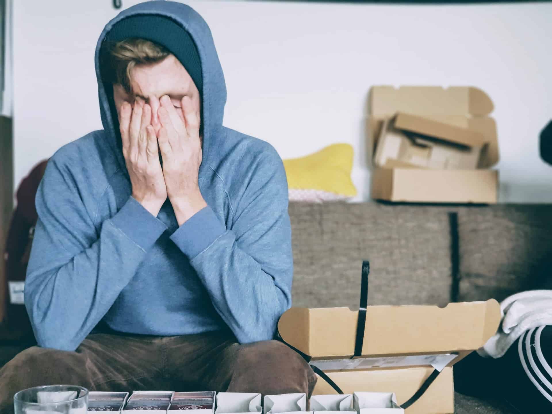 man covering face with hands