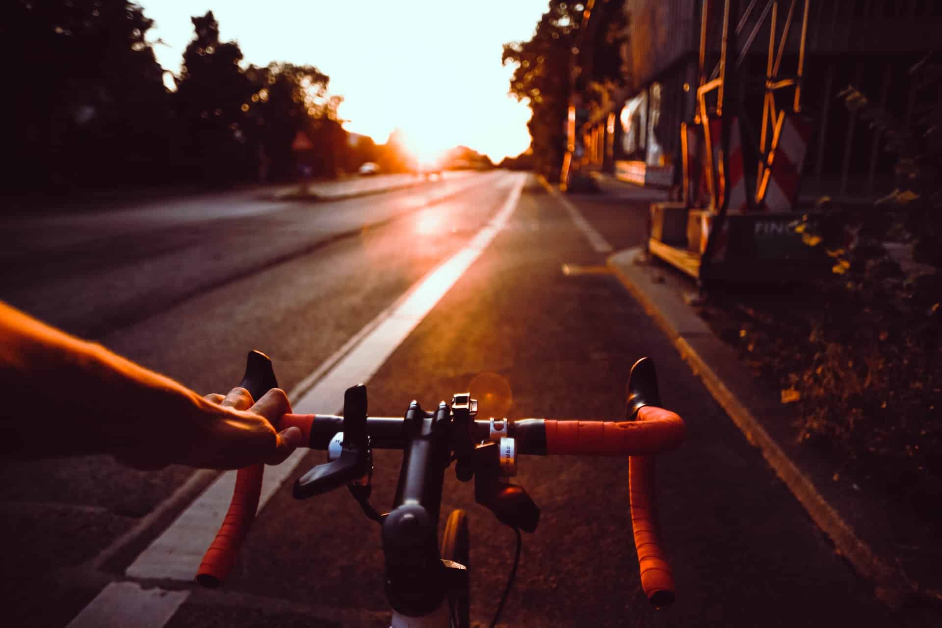 cyclist on road at sunset