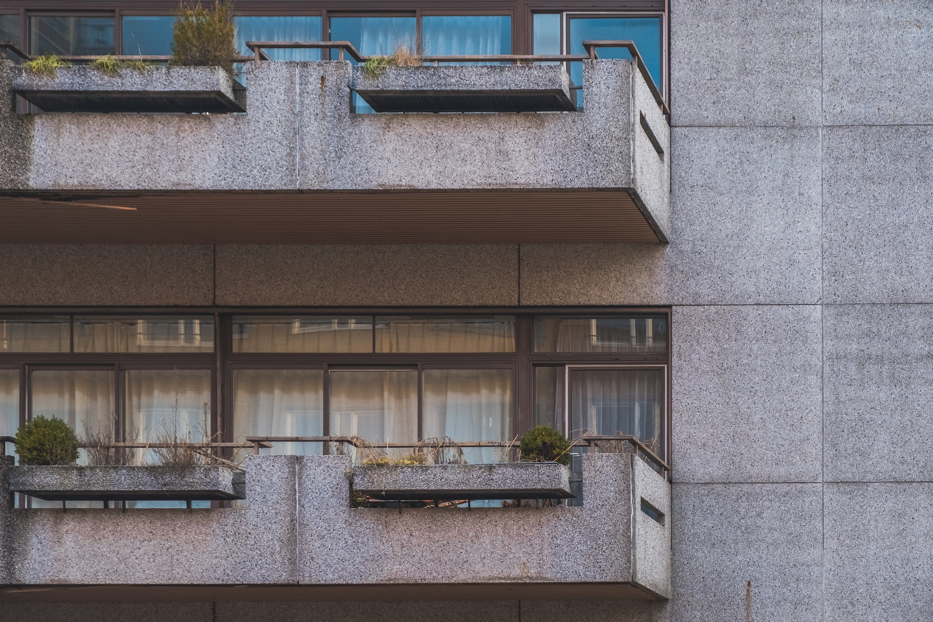 Two grey, concrete residential balconies, representing personal injury claims from balcony collapses and falls