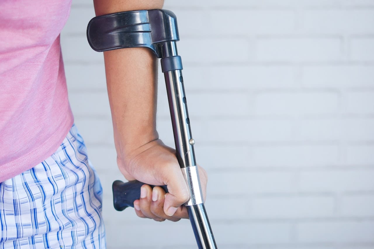 person holding black and silver walking stick