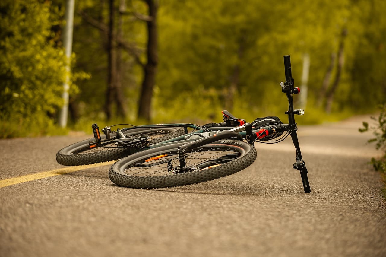 a mountain bike lying on pavement