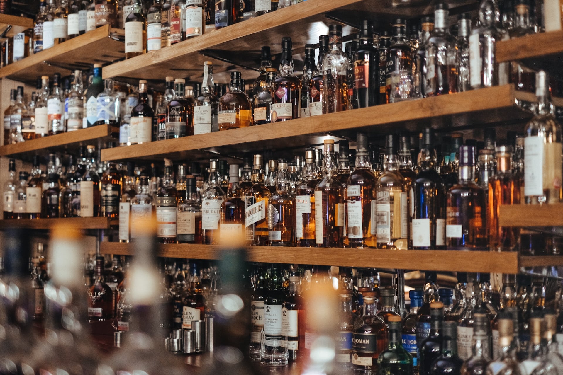 Assorted bottles of whiskey and scotch on a bar wall