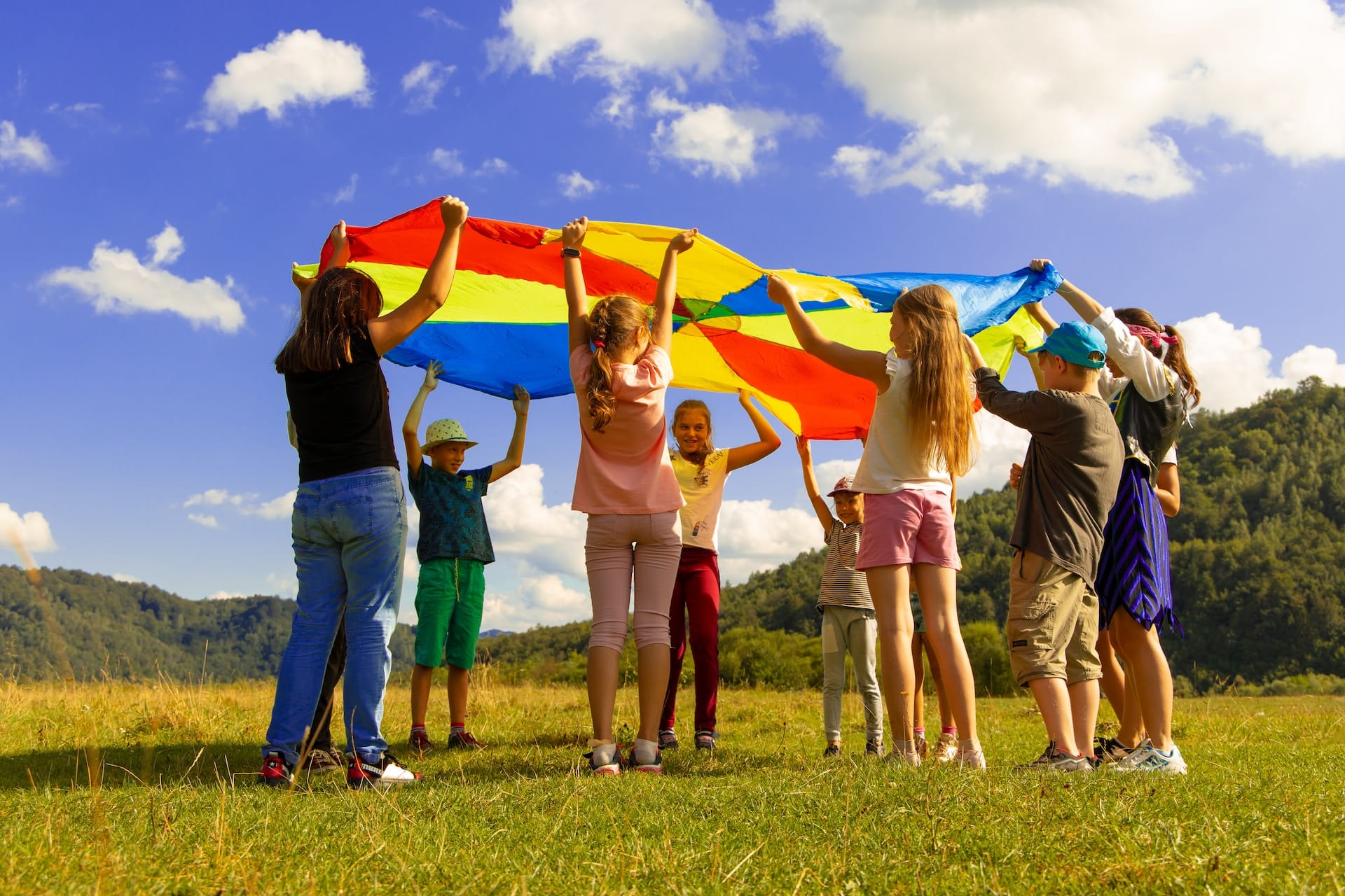 group of children lifting a parachute