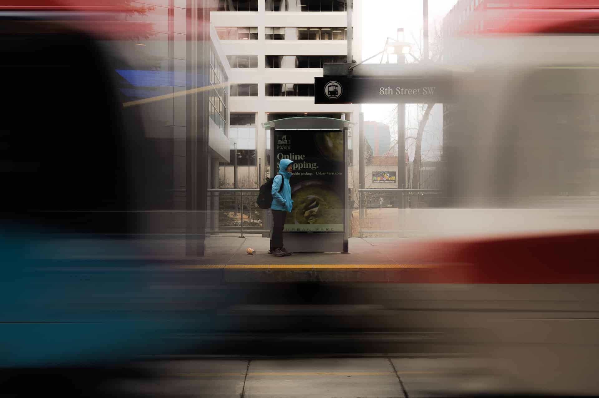 a blurry photo of a woman waiting for bus