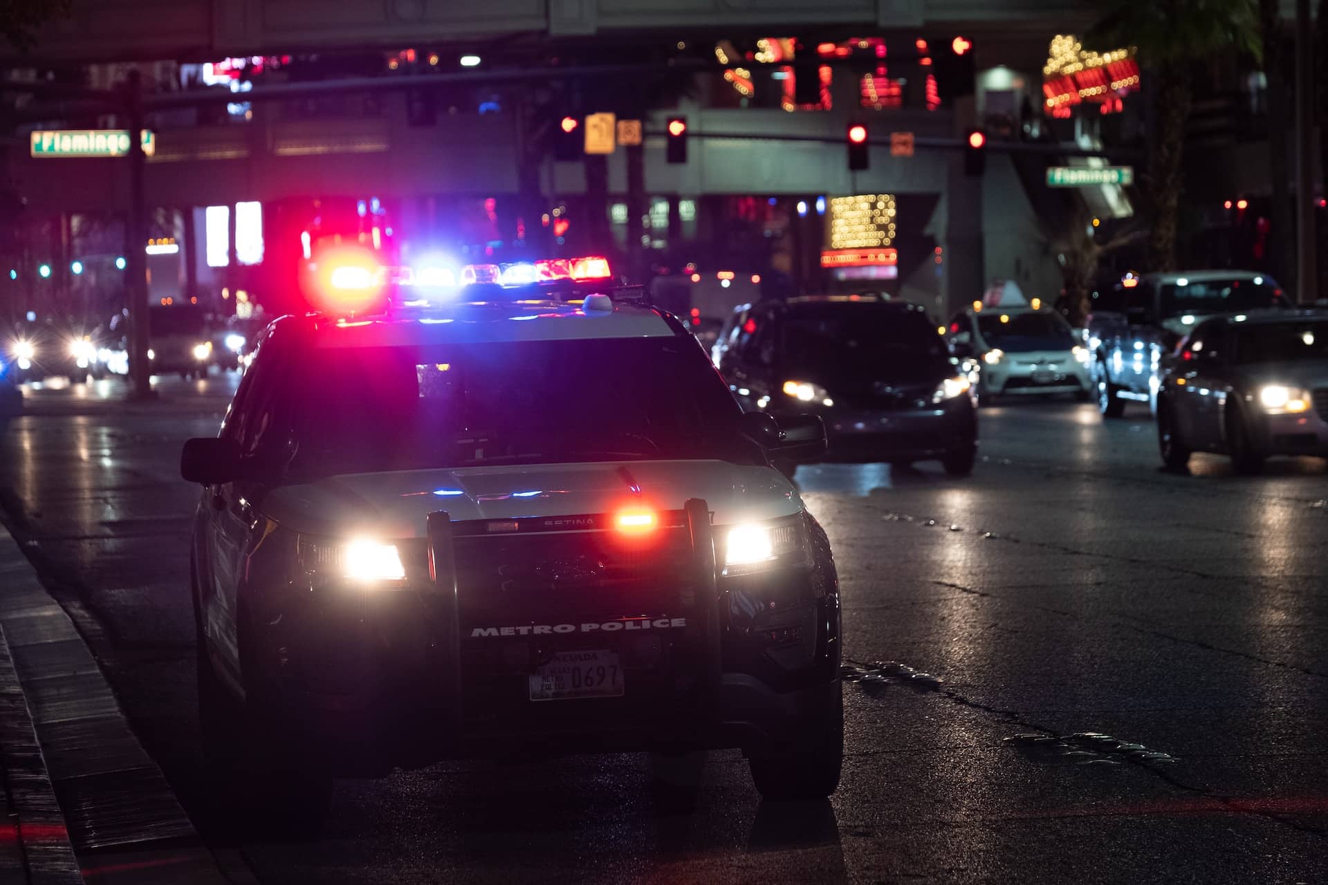 police car on side of road with lights on