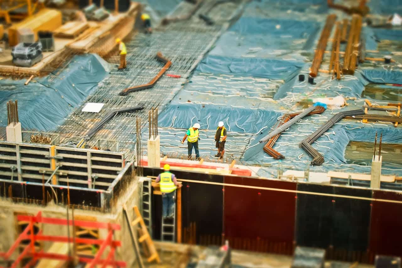 two construction workers on roof of a construction site