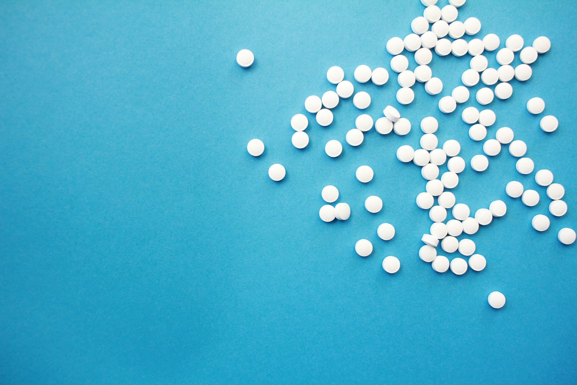 pills scattered across a blue counter