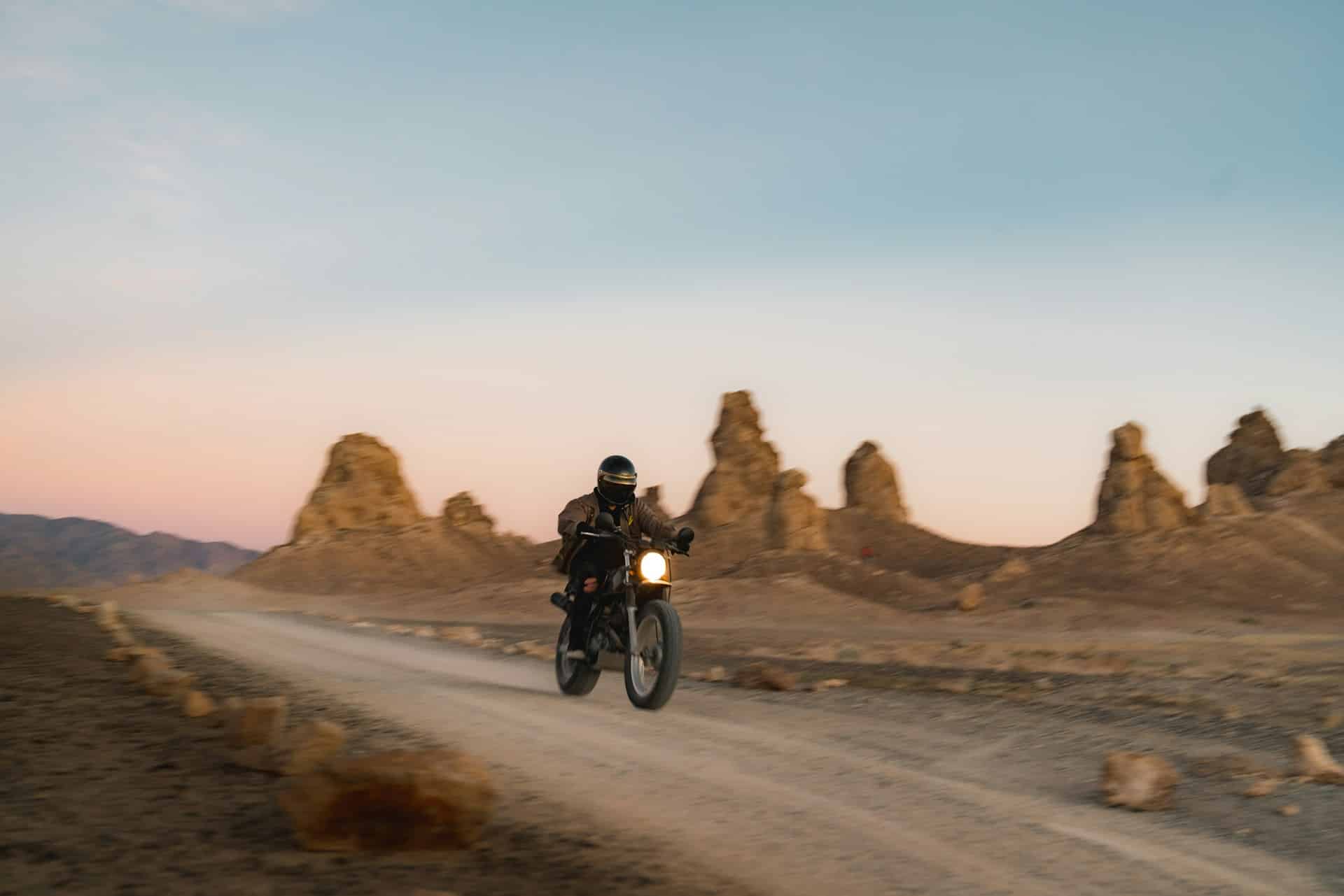 motoryclist on road in desert