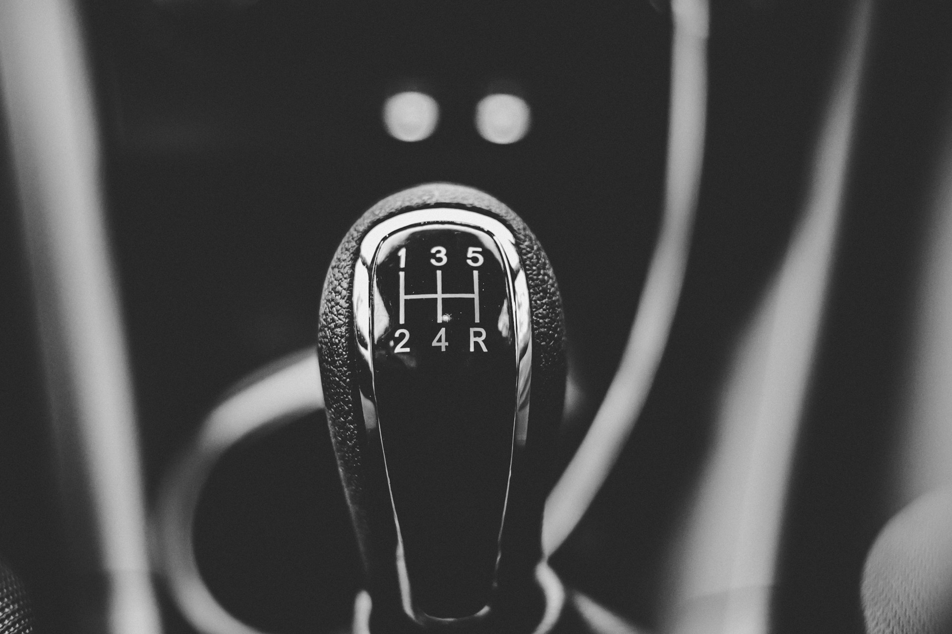 focus photography of a gear shift in black and white