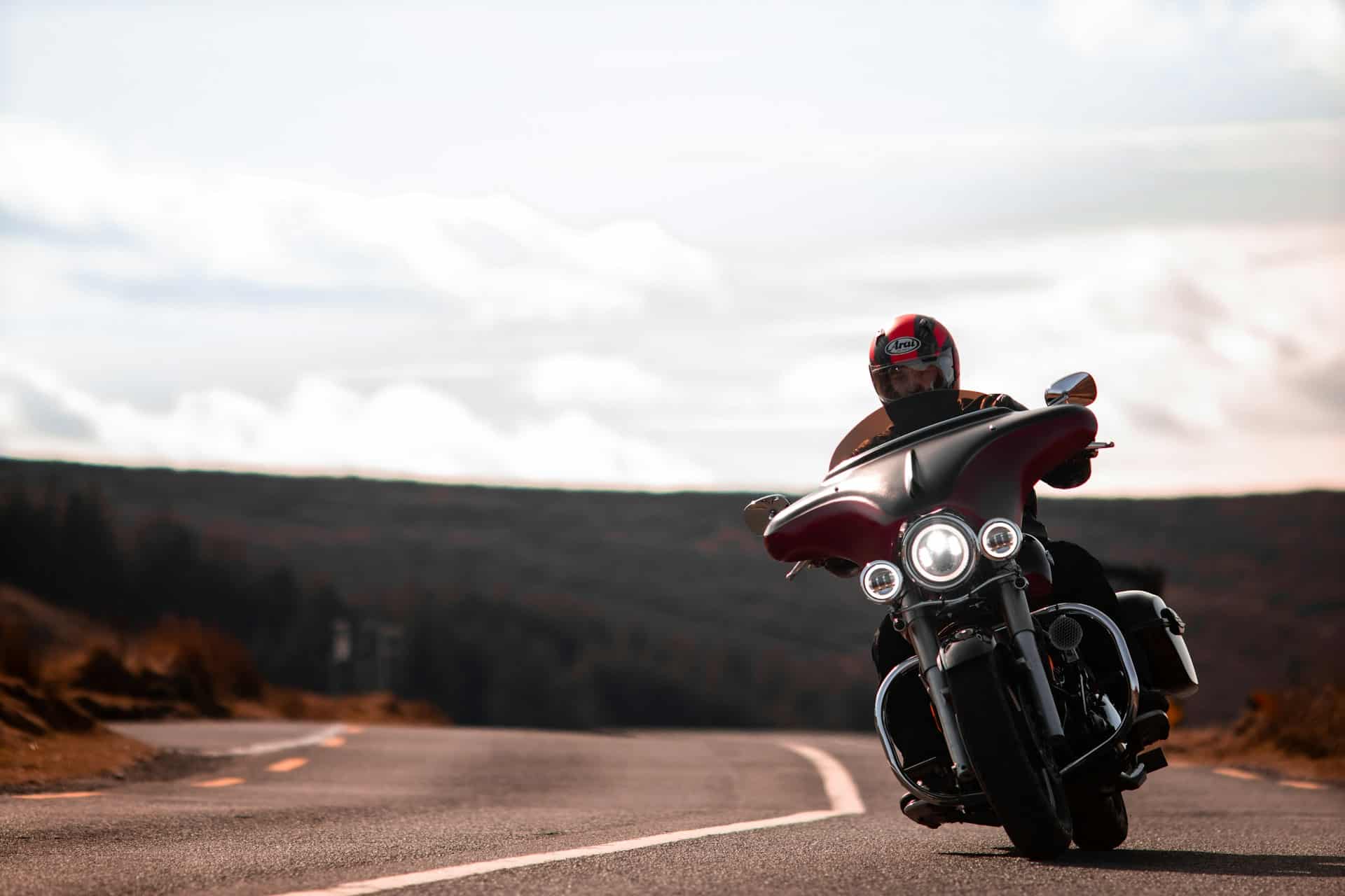 a person riding a motorcyle with their lights on