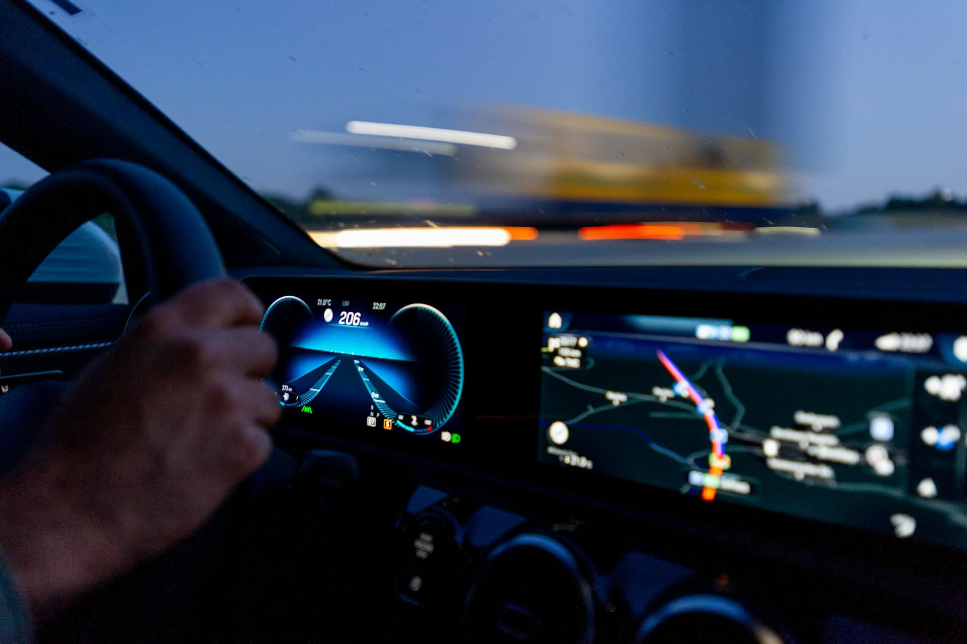 The dashboard of a car and blurred traffic through the windshield, representing fatal car accidents.