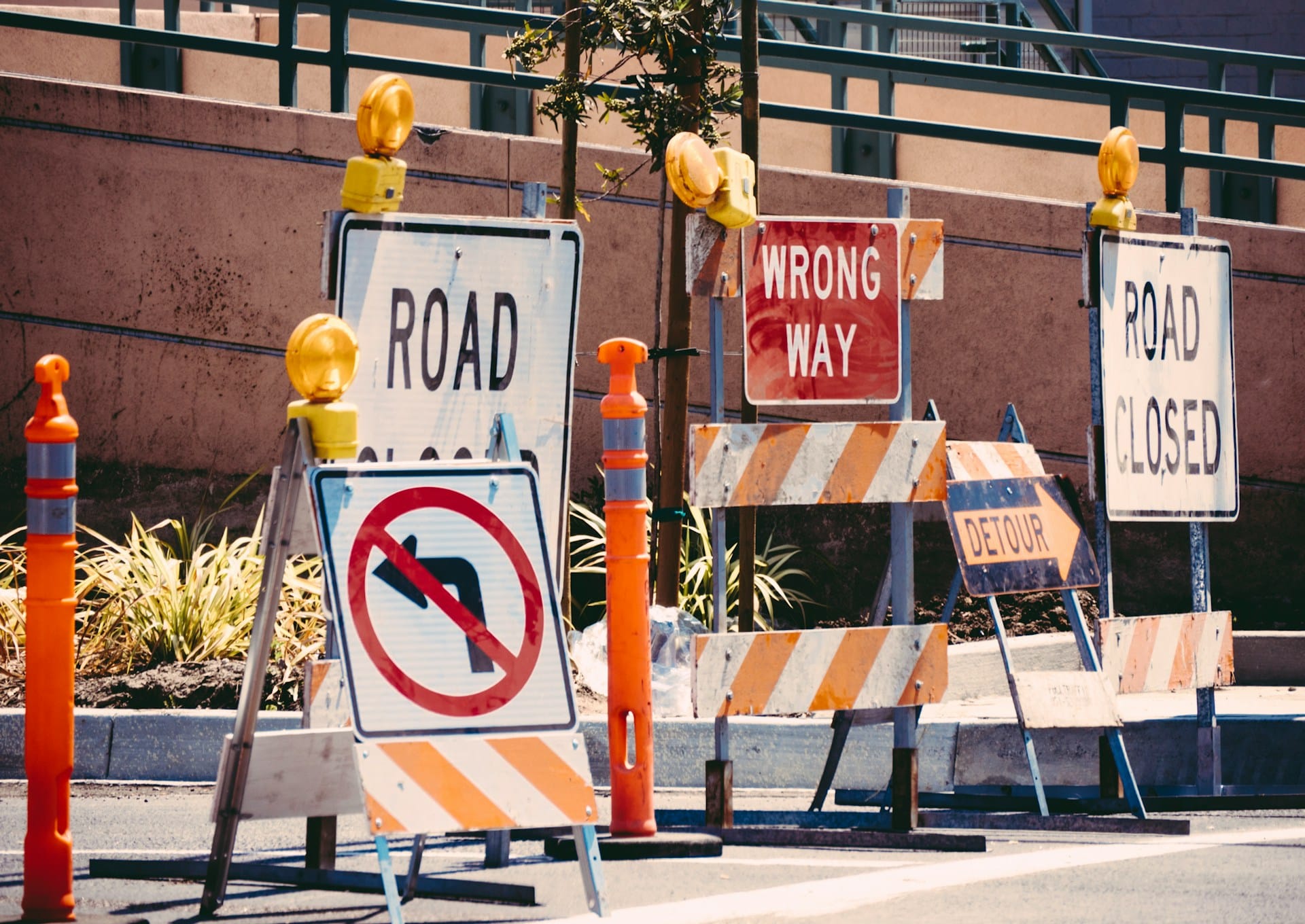 Multiple road construction signs (including “no left turn”, “Detour”, “Road Closed” and “Wrong Way”) on a roadway, representing construction zone accidents in Alberta.
