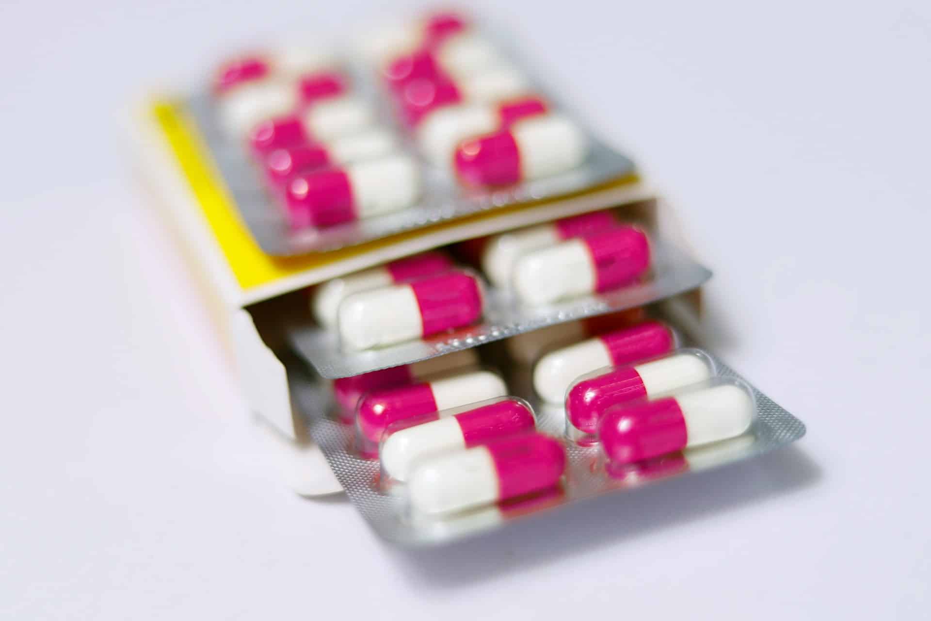 An unmarked package of pink and white pills, representing medical malpractice terminology in Alberta law