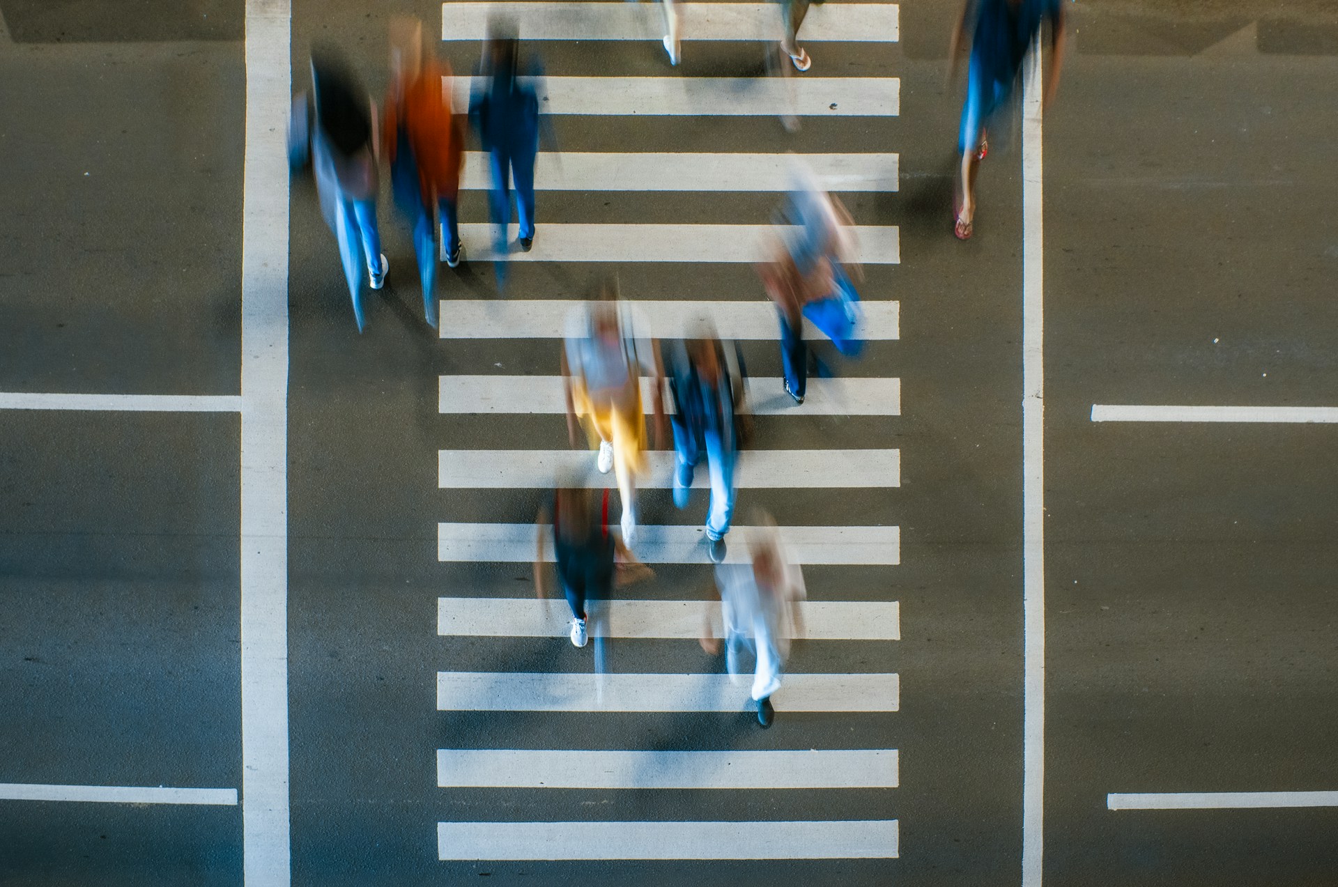 A group of people crossing the street at an intersection, representing pedestrian safety month in Alberta.