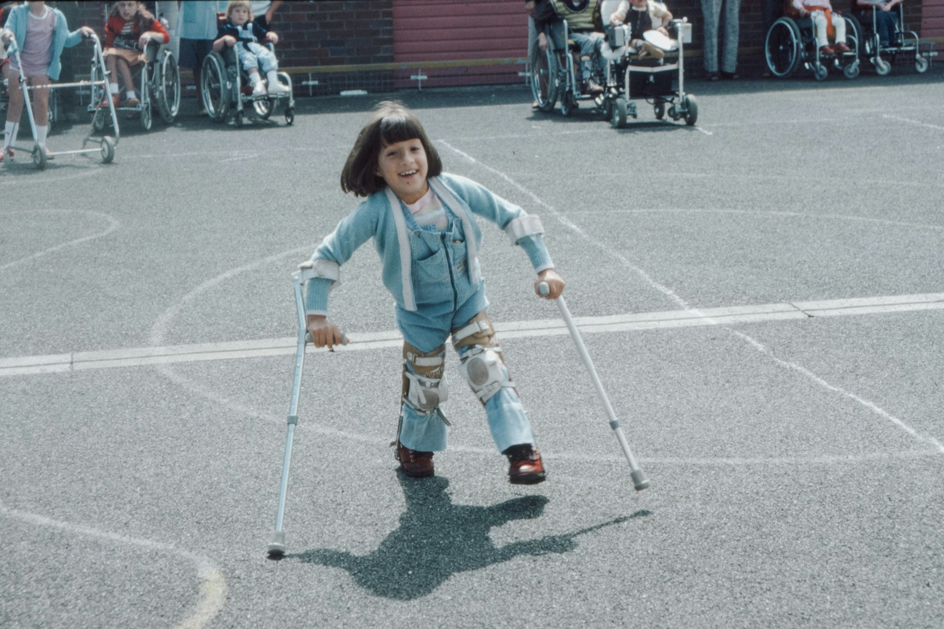 A young girl walking with assistive device representing cerebral palsy and birth injuries.